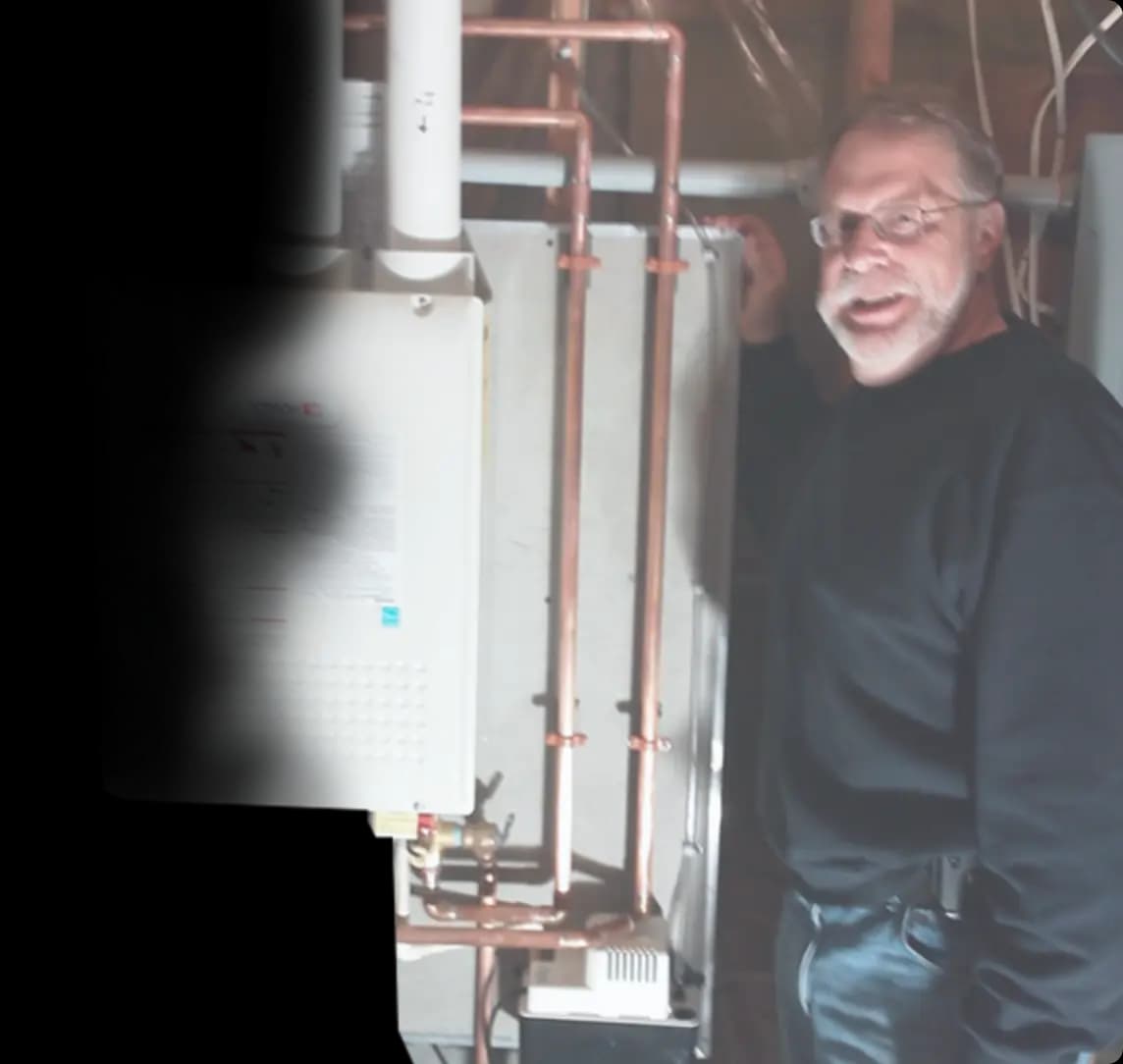 image of a man standing next to a water heater