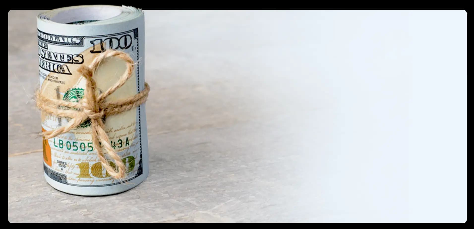 image of a rolled up hundred bills